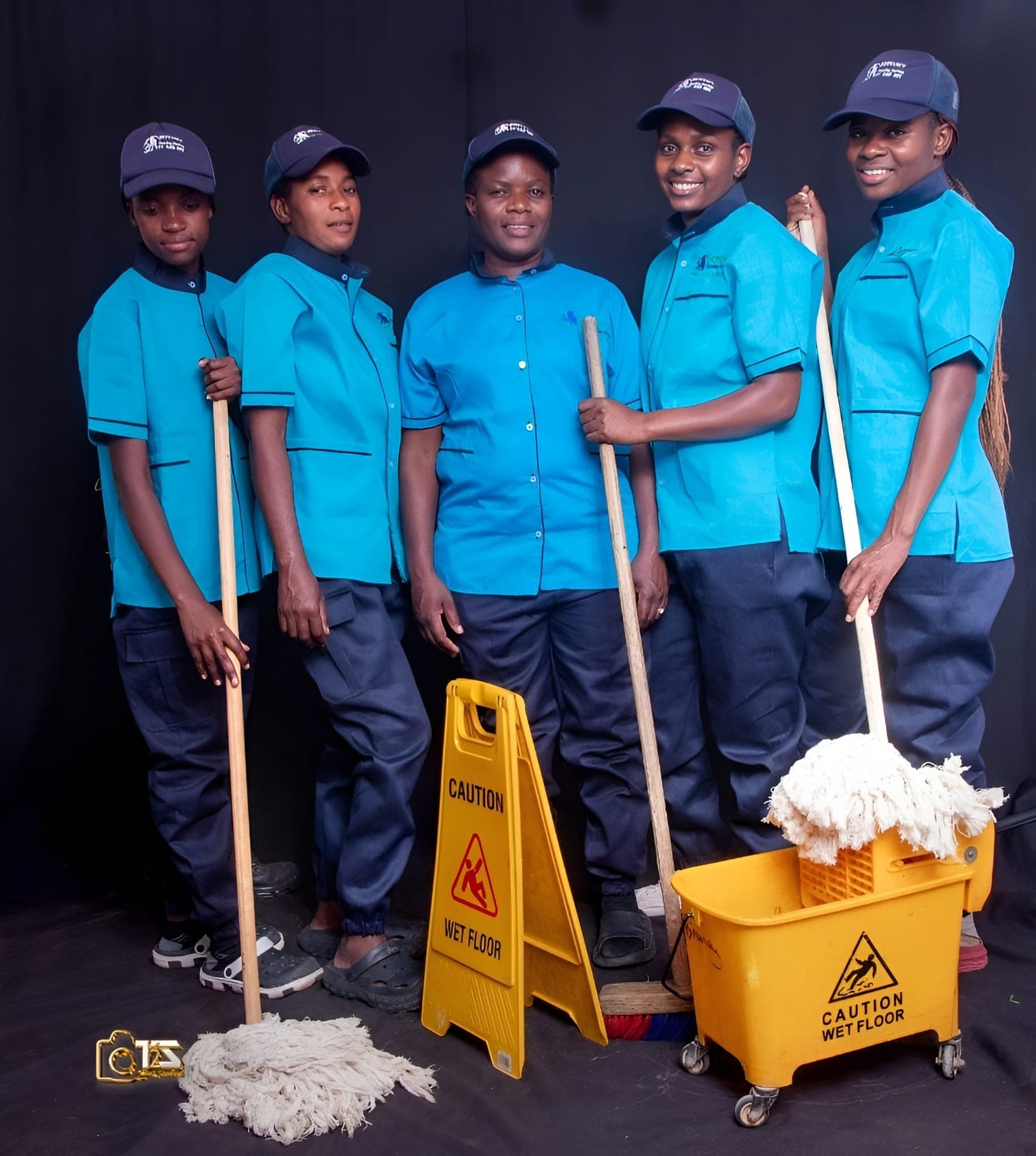 Four Brinancy cleaners in blue uniform with cleaning equipment