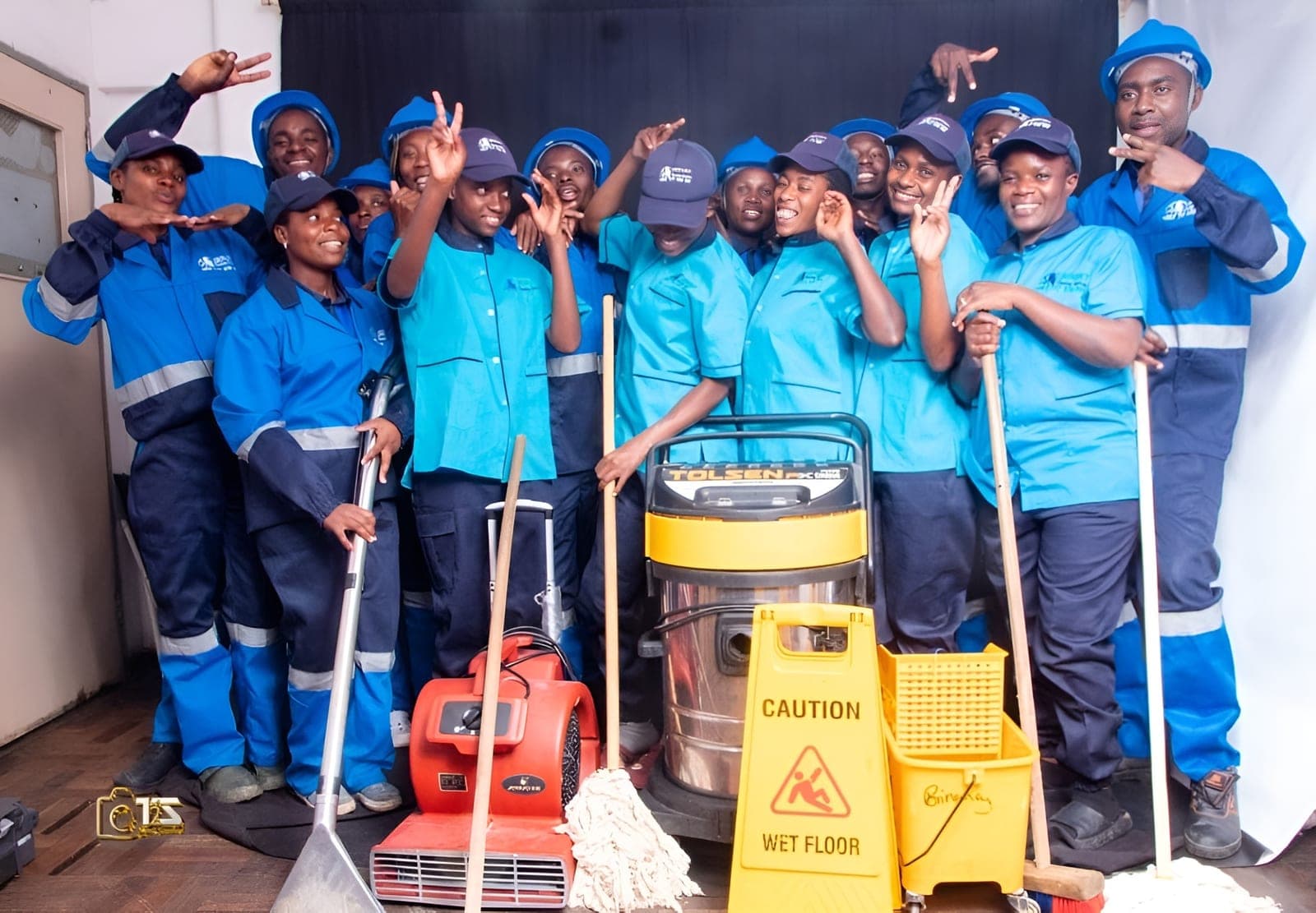 Brinancy cleaning team assembled with mops, brooms and machinery