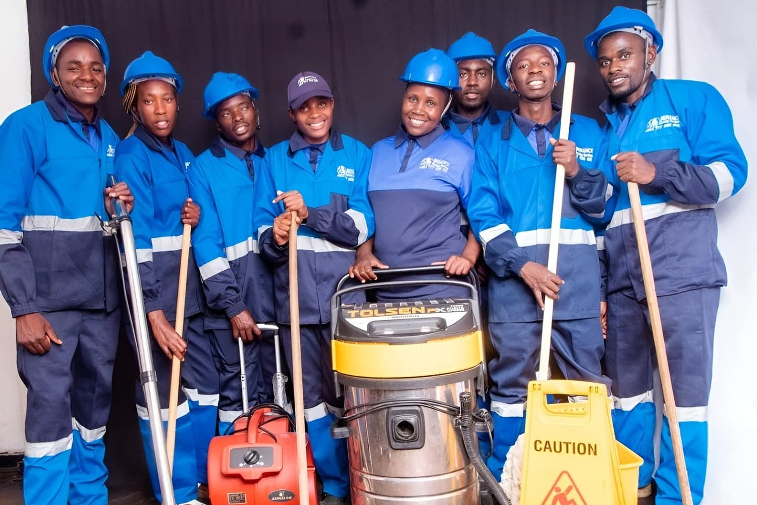 The Brinancy janitorial crew with their wet vacuum, brooms and wet-floor signage